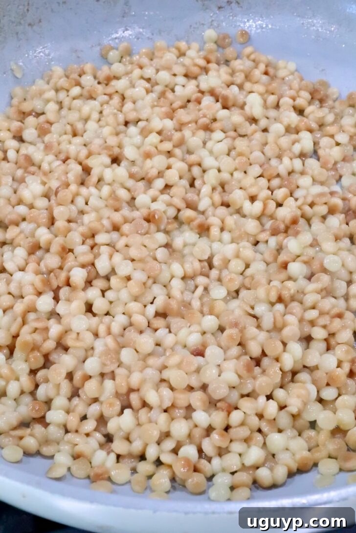 cooked pearled couscous in a skillet