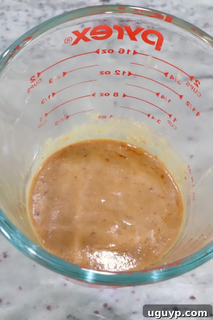 miso ginger sauce mixed up in a glass measuring cup